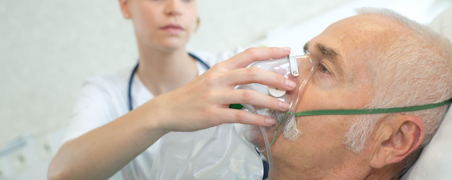 Elderly man getting oxygen