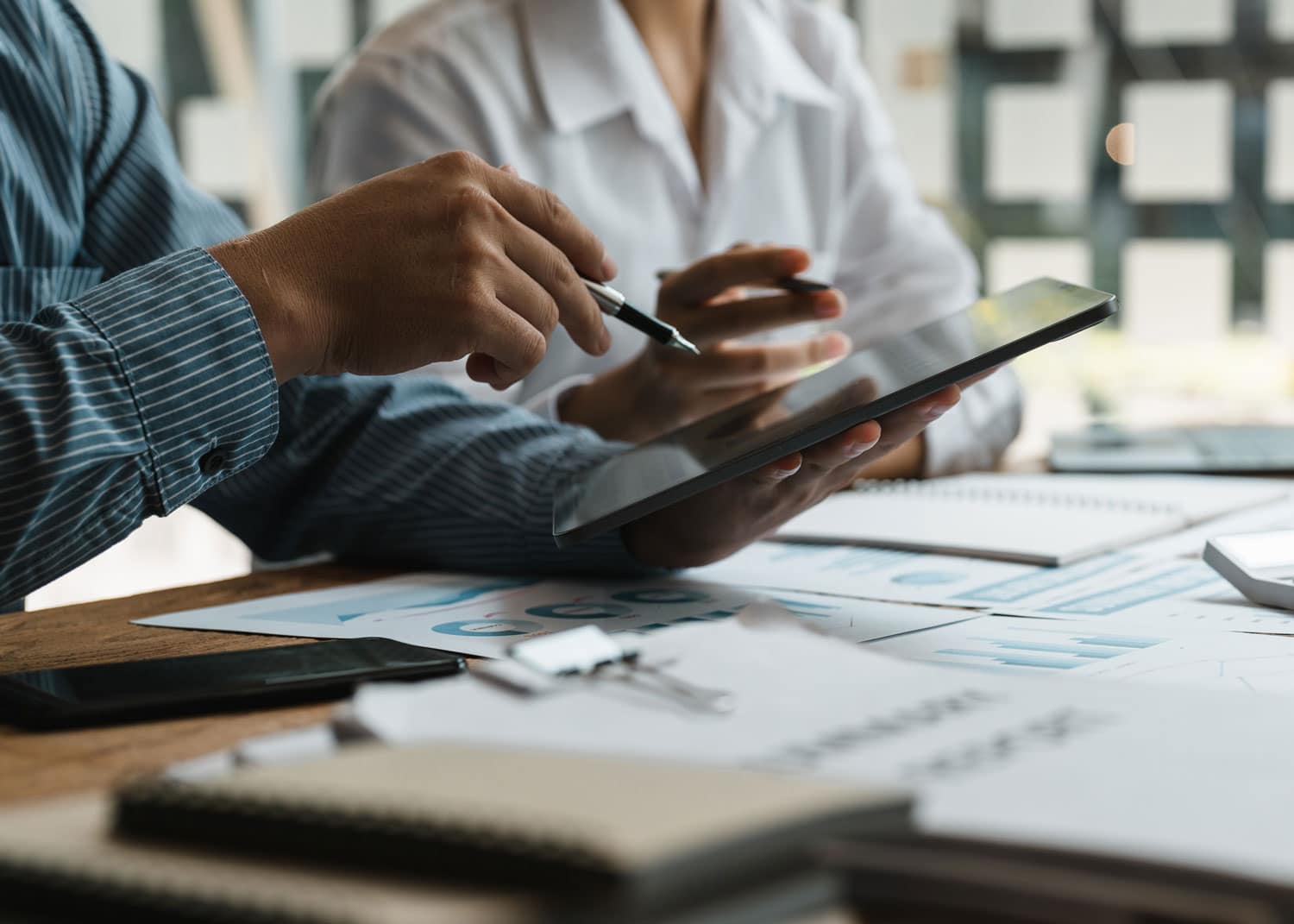 Professionals working on a tablet