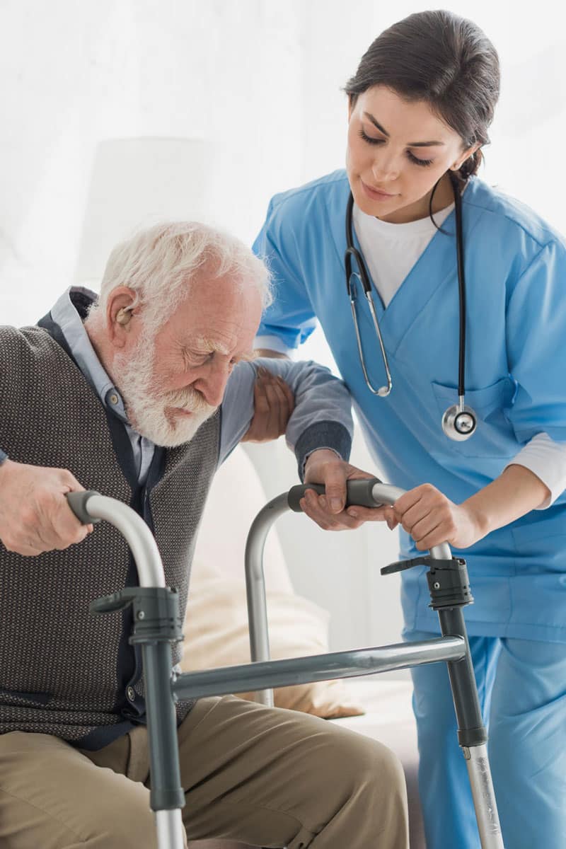 A nurse helping a patient to stand
