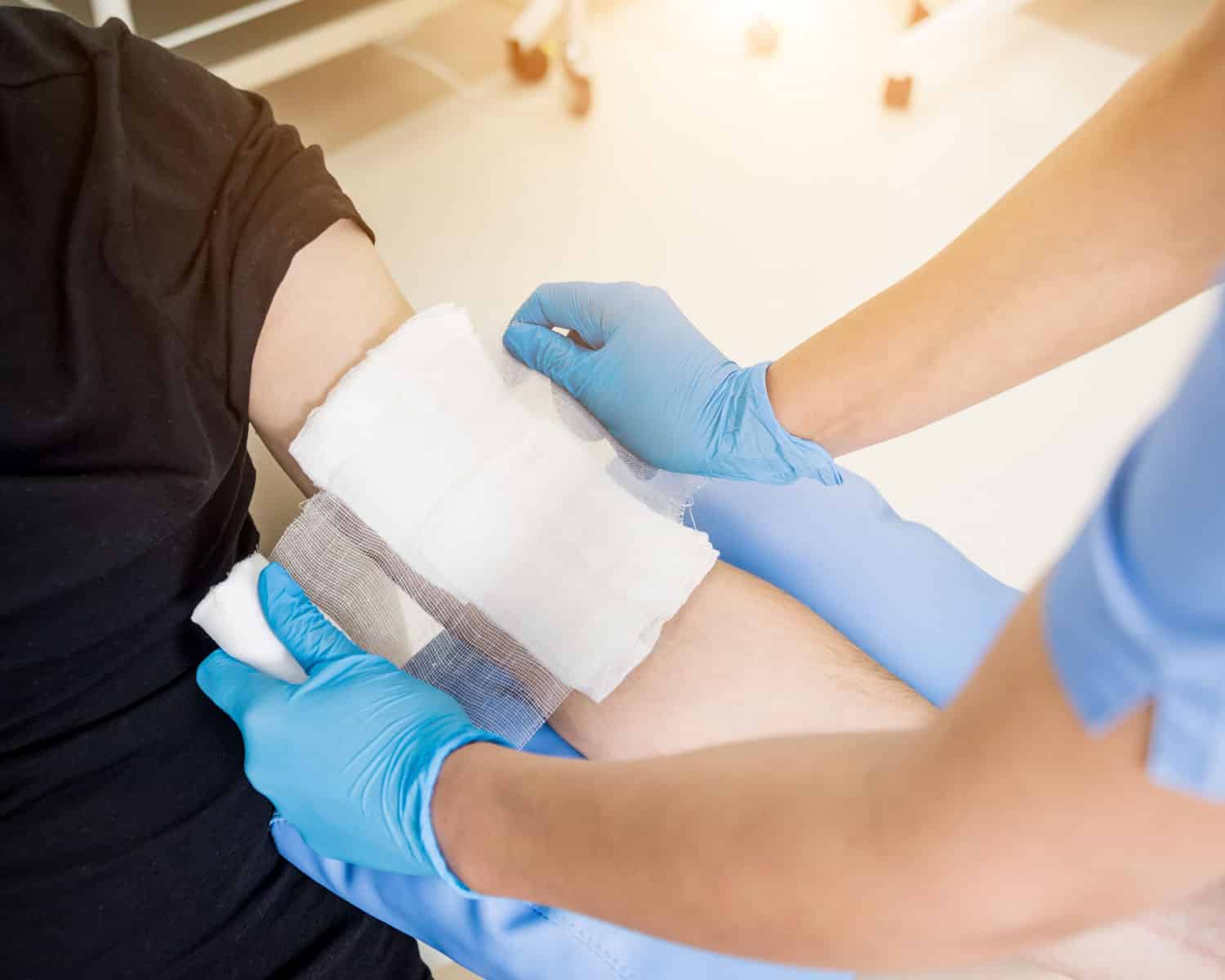 Nurse bandaging up a patient