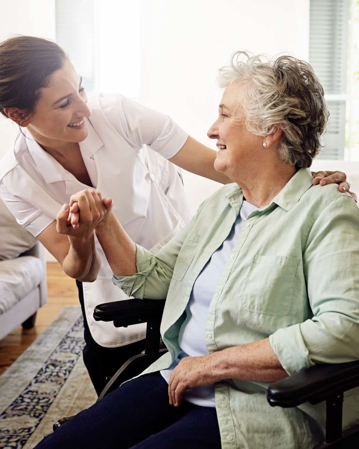 An Elderly woman talking with a care giver