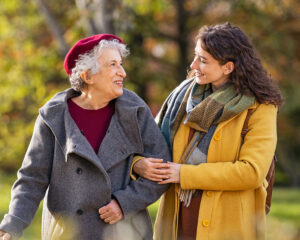 elderly woman walking with her daughter