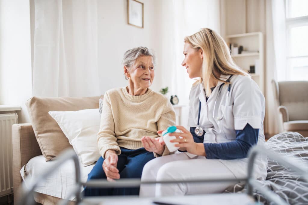 home health care provider helping a elderly patient