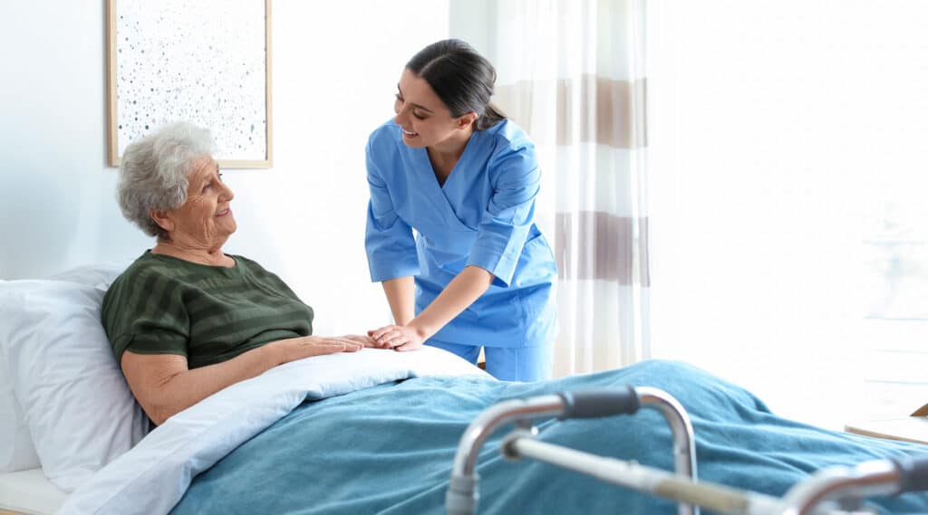 Hospice worker helping an elderly woman