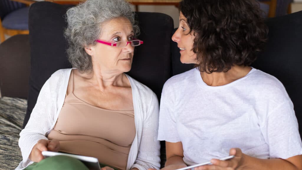 Elderly woman talking to another woman