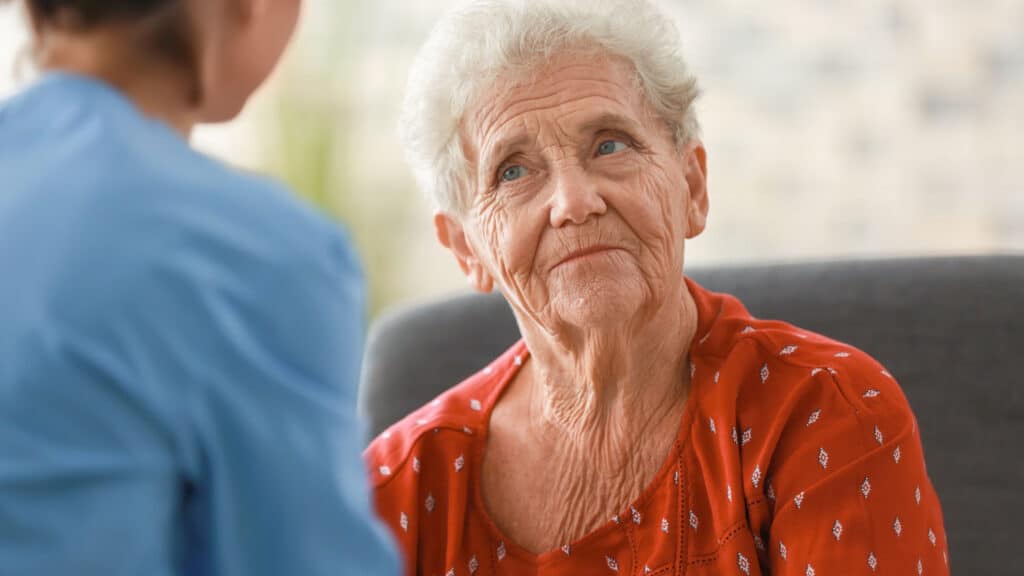 Elderly woman talking with a nurse