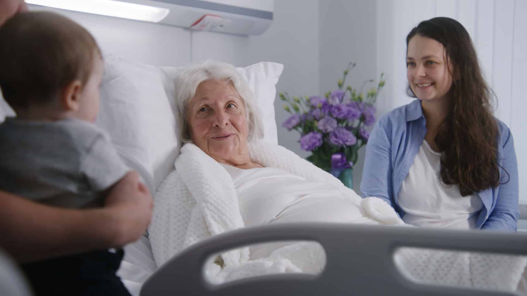 Family talking to an elderly woman